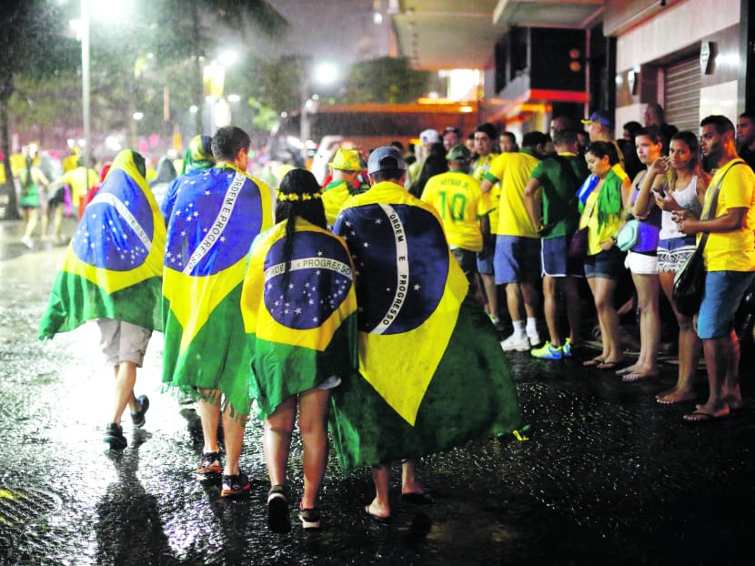 Dejected Brazil fans count the cost of their country’s failed bid to win the World Cup on home soil. Photo: REUTERS