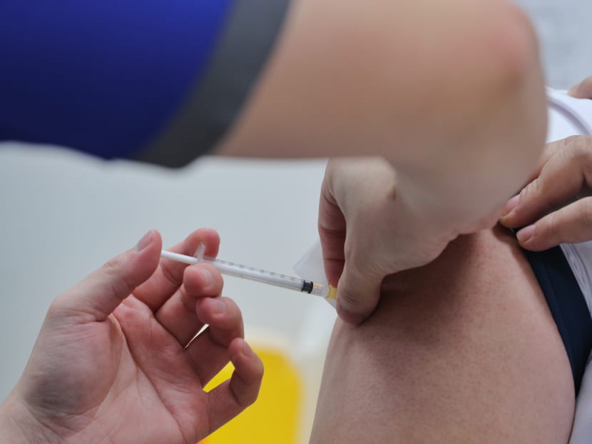 A healthcare worker receiving the Pfizer-BioNTech Covid-19 vaccine as Singapore rolls out the vaccination exercise. A healthcare worker receiving the Pfizer-BioNTech Covid-19 vaccine as Singapore rolls out the vaccination exercise.