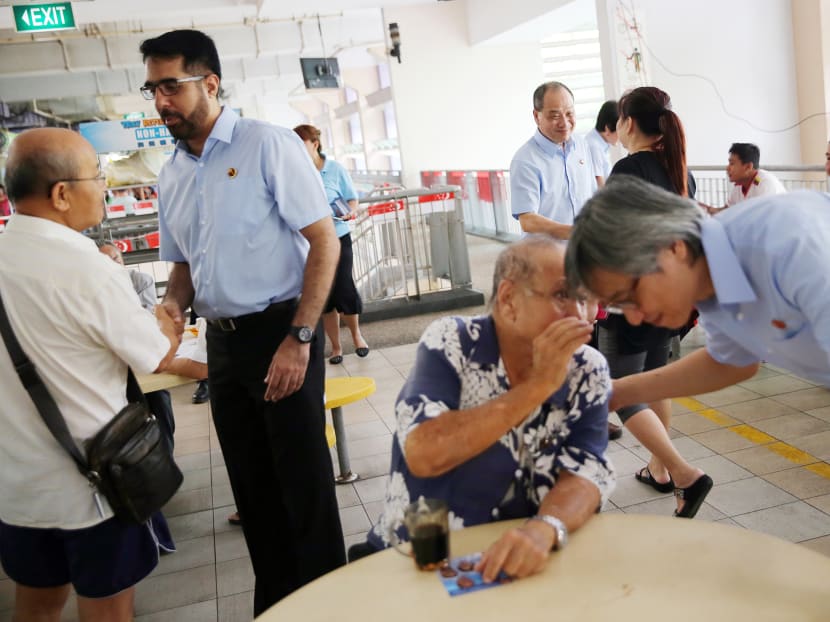 Members of the Workers' Party campaigning at a food centre in Hougang on Sept 2, 2015.