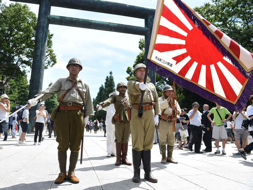 Men dressed in World War II Japanese military uniform visit the Yasukuni Shrine in Tokyo on Aug 15, 2014. Photo: Getty Images