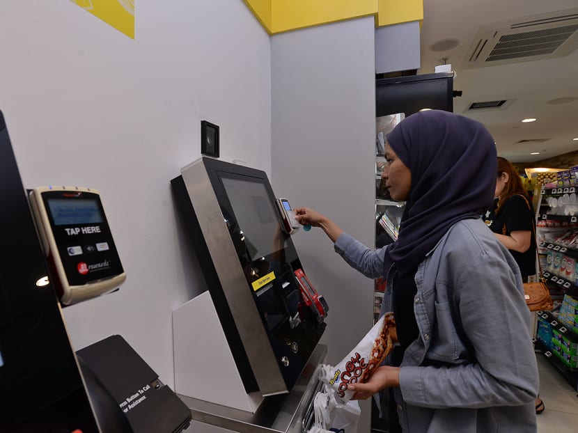 A student from Nanyang Polytechnic (NYP) making a purchase at the self-checkout kiosk in Cheer's first unmanned and cashless convenience store at Nanyang Polytechnic, on July 28, 2017. Photo: Robin Choo/TODAY