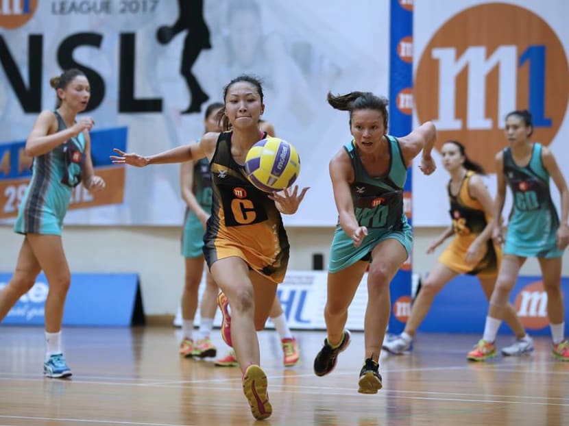 The Fier Orcas (in orange) put up a good fight but were just not good enough to beat the Tiger Sharks. Photo: David Wirawan/Netball Singapore