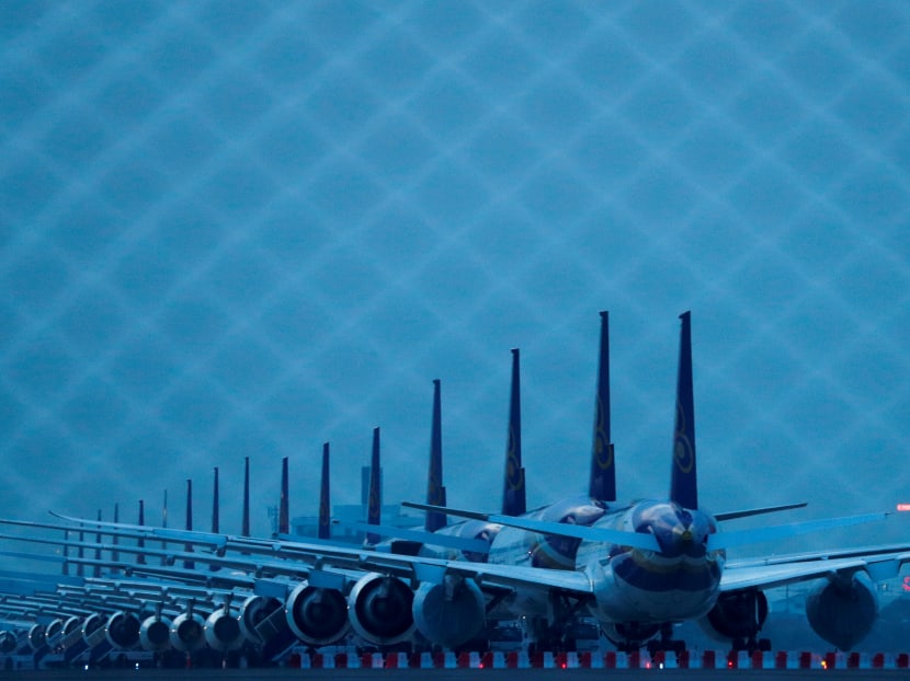 Thai Airways idle airplanes are seen parked on the tarmac of Suvarnabhumi Airport in Bangkok on May 25, 2020.