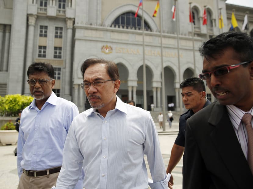 Malaysian opposition leader Anwar Ibrahim (second from left) leaving the court during his final appeal against a conviction for sodomy at the Palace of Justice in Putrajaya on Oct 31. Photo: Reuters