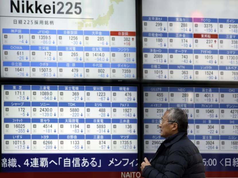 A man looks at an electronic stock board at a securities firm in Tokyo,on Feb 9, 2016. Photo: AP