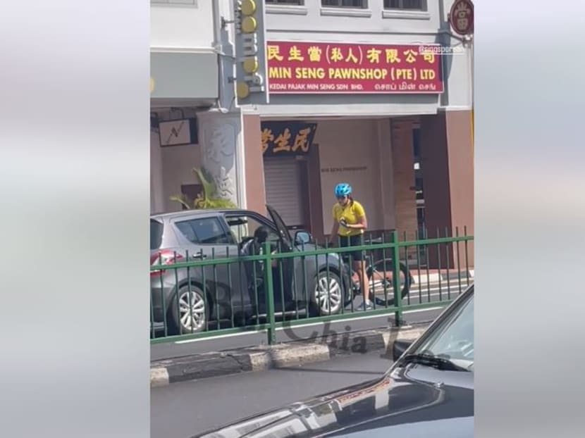 In a scene from a 39-second video published on Facebook page Beh Chia Lor, a cyclist and a car driver are apparently obstructing traffic along East Coast Road before the cyclist jumps onto the car bonnet.