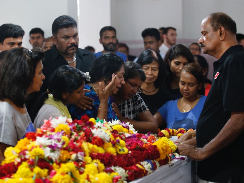 Family members and friends of Pradip Subramanian at the wake of the 32-year-old bodybuilder. Mr Subramanian suffered "a cardiac arrest respiratory failure episode" following his Asia Fighting Championship (AFC) fight with YouTube personality Steven Lim on Saturday (Sept 23). Photo: Najeer Yusof/TODAY