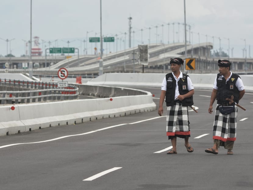 Photo of the day: Balinese traditional security guards called 'Pecalang' walk as they patrol an empty highway during Nyepi, the holy day of Silence, in Bali, Indonesia, March 7, 2019.