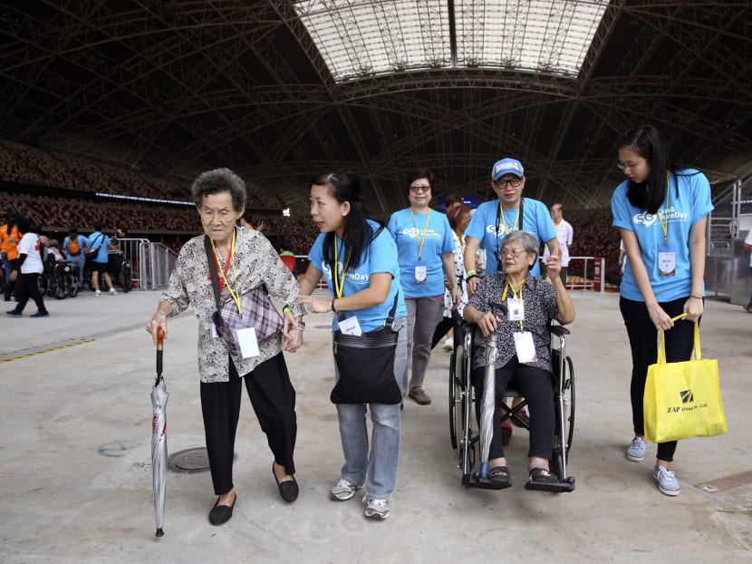 Elderly beneficiaries brought on a tour of the Singapore Sports Hub by corporate volunteers. TODAY file photo