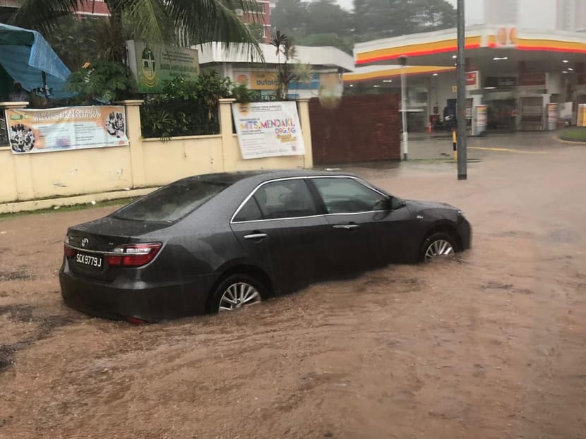 A photo circulating on social media showing a car with its wheels submerged in brown, murky waters near a Shell petrol station.
