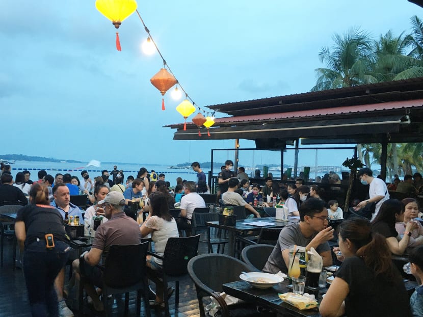 People having dinner at a restaurant in Pasir Ris Park, Singapore.