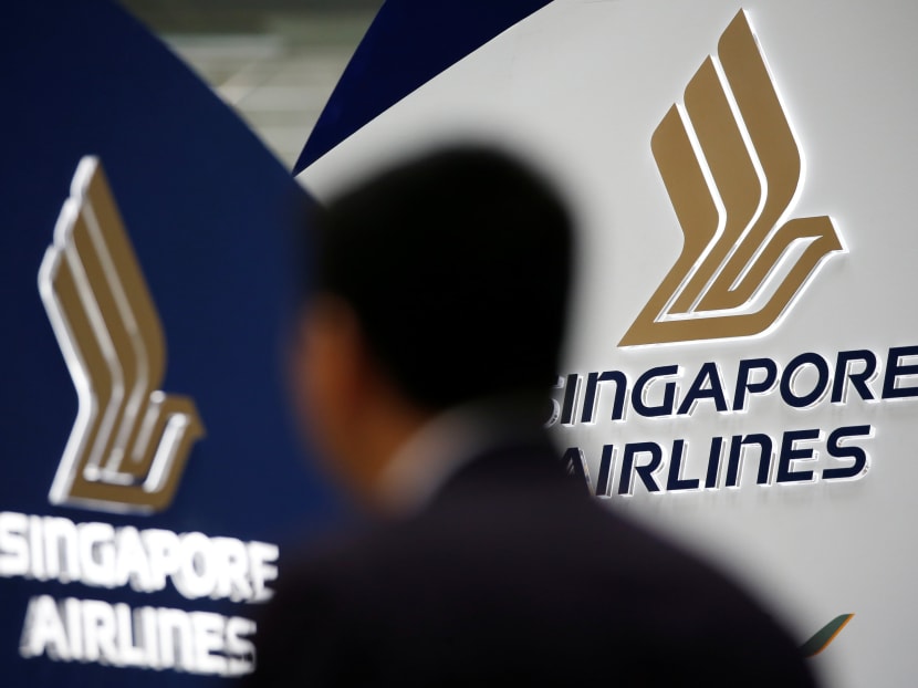 A man walks past a Singapore Airlines signage at Changi Airport in Singapore May 11, 2016. Photo: Reuters