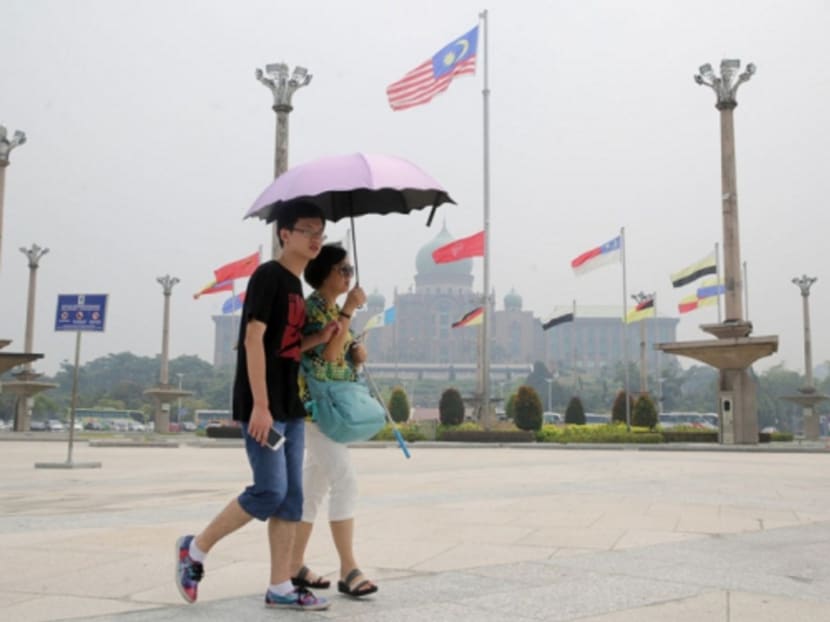 Tourists on a hazy day in Putrajaya yesterday. Transboundary haze suffocated the region in smoke last year, affecting tens of millions of people. Photo: Malay Mail Online