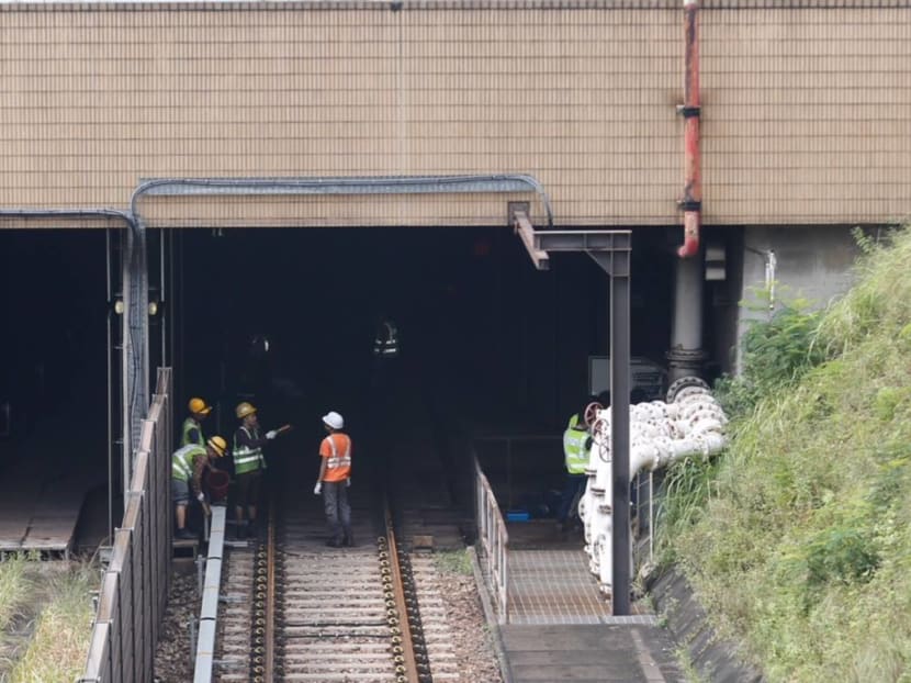 SMRT engineers are seen near the entrance of the Bishan tunnel as they work to clear rain water from the tunnel and resume regular service on Oct 7. Photo: Najeer Yusof/TODAY