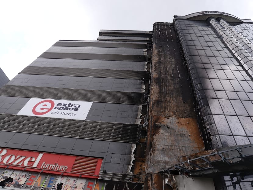 Aftermath of the warehouse fire at 30 Toh Guan Road on May 4, 2017. The authorities will adopt the recommendations put forward by an advisory panel to improve fire safety, including reviewing the regulatory regime for cladding.