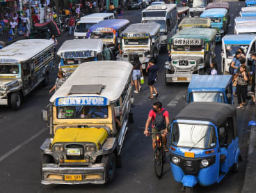 In this photo taken on April 5, 2024, jeepneys commute along a street in Manila. 