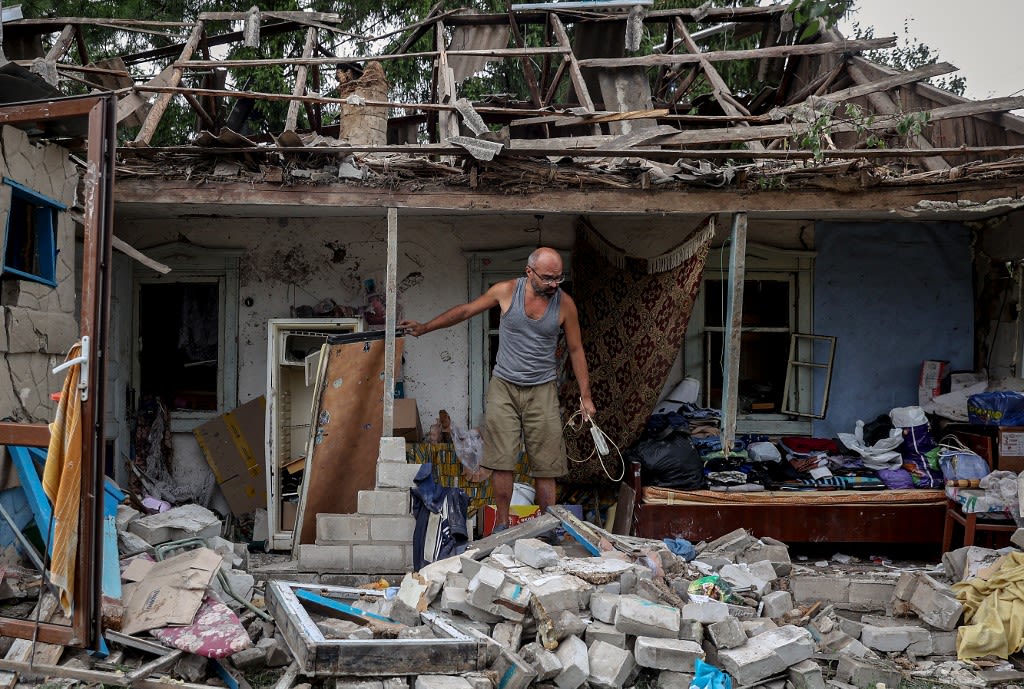 A local resident collects belongings from his destroyed house after a night missile strike in the town of Kramatorsk, in Donetsk region, on Aug 16, 2022, amid the Russian military invasion of Ukraine.
