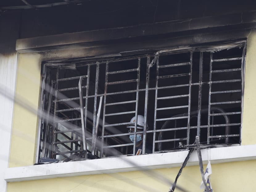 Forensic police officer investigates burnt windows at an Islamic religious school following a fire on the outskirts of Kuala Lumpur Thursday, Sept. 14, 2017. The official said the fire, which killed people, mostly teenagers, started early Thursday at the top floor of the three-story building. Photo: AP