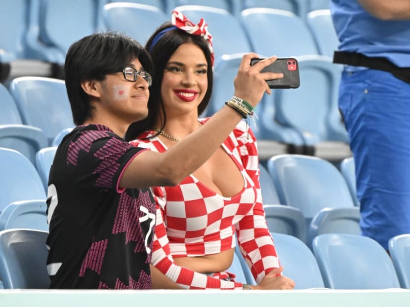 Croatian influencer Ivana Knoll poses for selfies with a Japan supporter ahead of the start of the Qatar 2022 World Cup round of 16 football match between Japan and Croatia at the Al-Janoub Stadium in Al-Wakrah, south of Doha on Dec 5, 2022.
