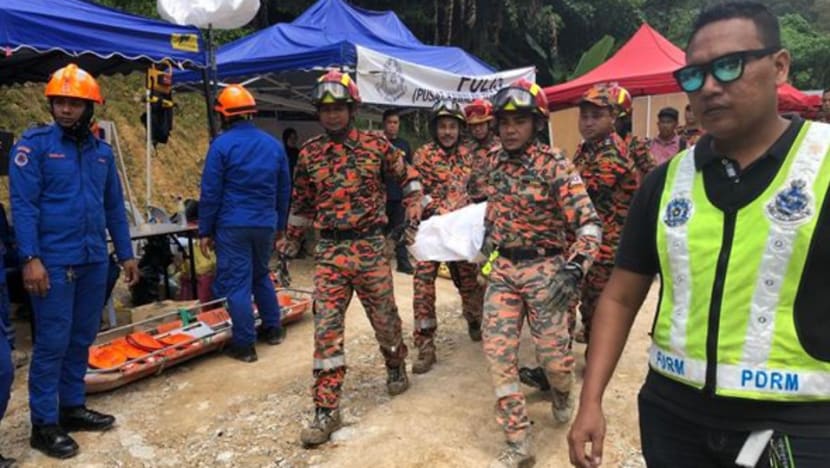 Father pulls out son's body from Penang landslide Father pulls out son's body from Penang landslide