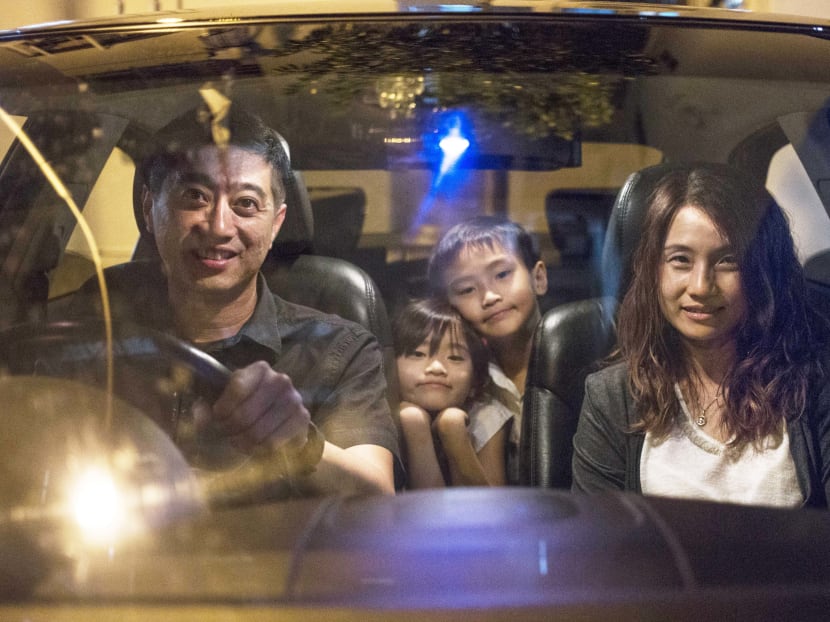Mr Toni Teh and his wife Madam Charlemagne Lim with two of their three children, Isabelle Teh and Russell Teh, in their family car. Photo: Wong Pei Ting