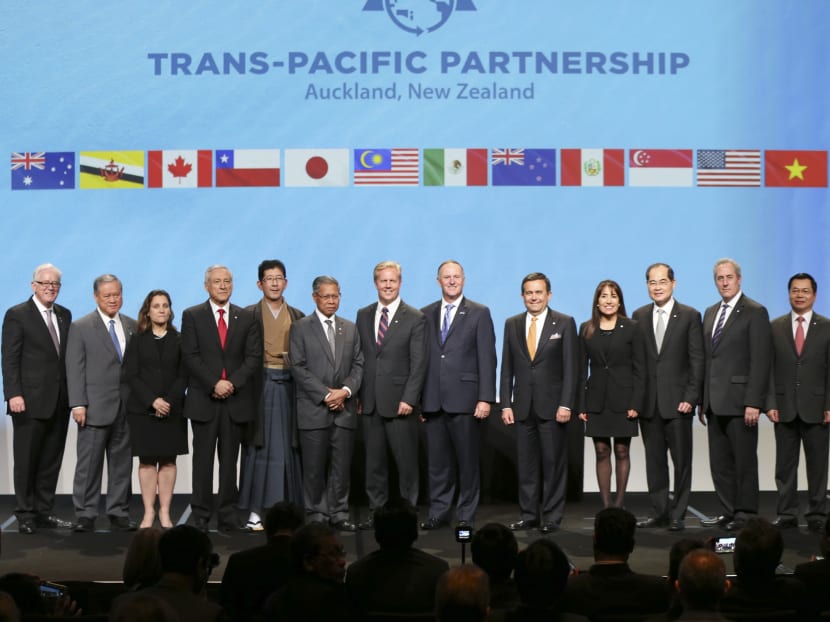 Trade delegates pose for the official photograph with the New Zealand Prime Minister John Key, centre, after signing the Trans Pacific Partnership Agreement, SkyCity Conference Centre, Auckland, New Zealand, Thursday, Feb 4, 2016. Photo: SNPA via AP