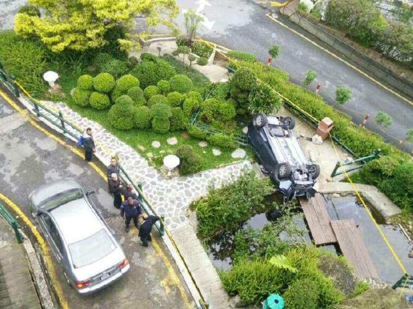 The car crashed through a barrier before plunging 13m into a mini park. Photo: New Straits Times