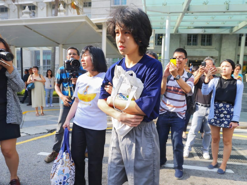 Amos Yee leaving the State Courts with his parents on July 6, 2015, after being sentenced to four weeks' jail, backdated to June 2nd. Photo. Ernest Chua