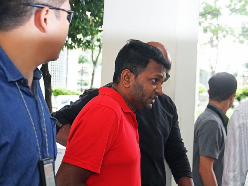 42-year-old  suspect, Annadurai S/O Raman involved in the Aljunied arm robbery of a money changer was brought to Geylang East Ave 1 Block 125, one of the places that is believed to be one of the crime scenes, to tell the police officers what happened there in regards to the crime.
