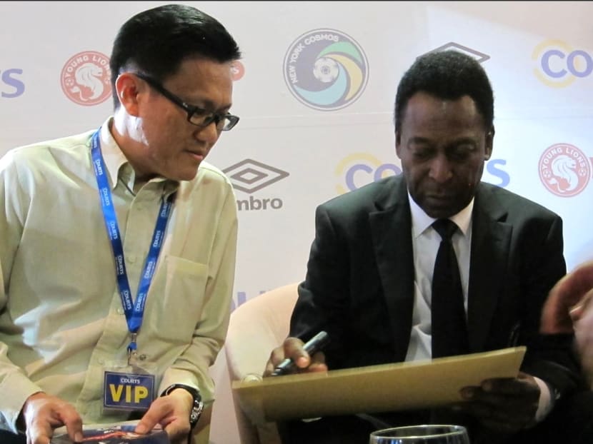 Football enthusiast Andrew Koh (left) sitting beside Pele (right) at a meet-and-greet session at Jalan Besar Stadium in March 2011. 