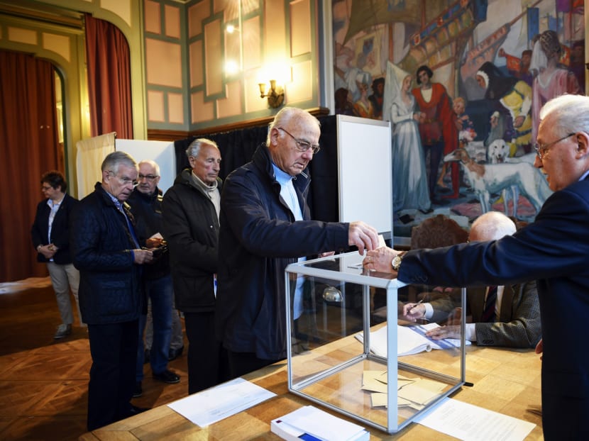Voters casting their ballots at a polling station in Le Touquet yesterday. Unemployment, France’s lacklustre economy and security issues are among the top concerns for voters. Photo: AFP
