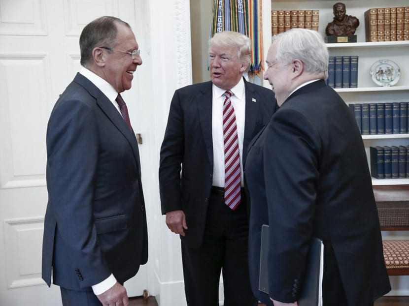 President Trump (centre) meeting Russian Foreign Minister Sergey Lavrov (left) and the Ambassador to the US Sergey Kislyak at the White House on Wednesday, hours after dismissing Mr James Comey as director of the FBI. Photo: The New York Times