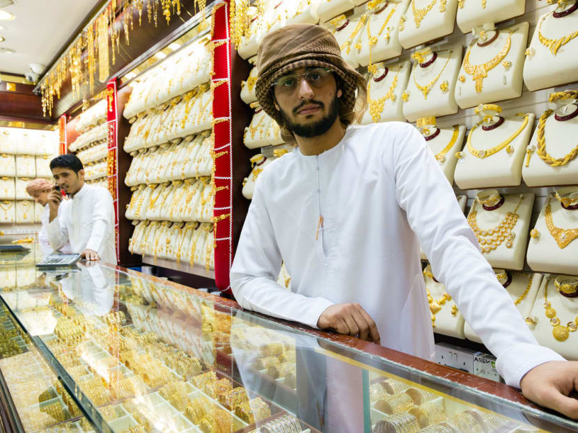 Gold traders in the Dubai Gold Souk. Now, with crude almost half the price of a year ago, gold buyers are harder to find as Middle East demand for the metal slows and the city sees a drop-off in some visitors. Photo: Bloomberg