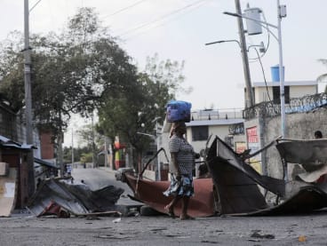 FILE PHOTO: A woman walks past a barricade amid gang violence in Port-au-Prince, Haiti March 3, 2023. REUTERS/Ralph Tedy Erol/File Photo