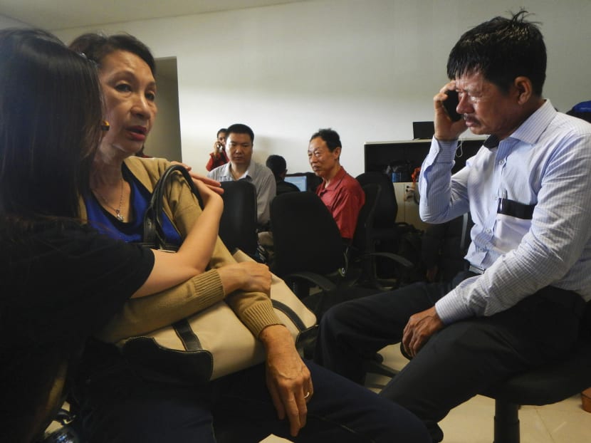 Family members of passengers on board AirAsia flight QZ 8501 wait for information inside a crisis centre at Juanda Airport in Surabaya. Photo: Reuters