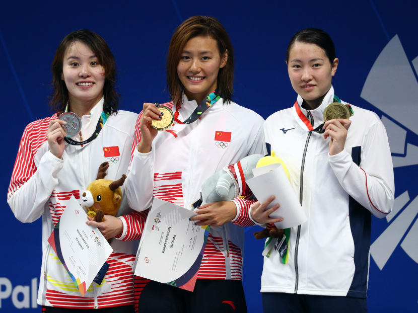 (From L - R) Silver medalist Fu Yuanhui of China, Gold medalist Liu Xiang of China and bronze medalist Natsumi Sakai of Japan on the podium.
