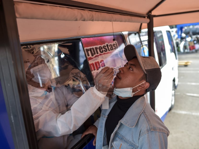 A passenger undergoes a rapid antigen test for the Covid-19 coronavirus prior to boarding a flight at Juanda international airport in Sidoarjo, East Java, on Dec 22, 2020.