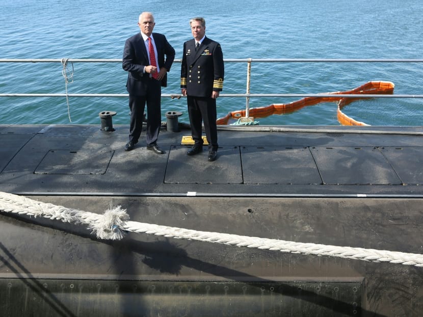 Australian Prime Minister Malcolm Turnbull (L) stands on a submarine in Adelaide on April 26, 2016, after announcing that French naval contractor DCNS had won a A$50 billion contract to design and build Australia's next generation of submarines. Photo: AFP