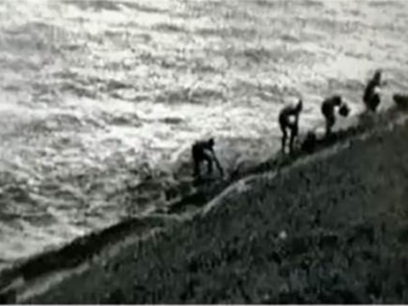 Photo of the four men on Singapore's shore after they disembarked from an unnumbered boat off Tuas Reclaimed Land on Oct 9, 2020.