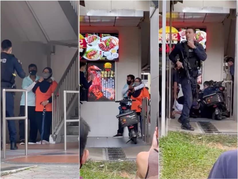 Screenshots of videos posted on Facebook of a confrontation between a man holding a woman hostage at knifepoint and the police at a coffee shop in Yishun.