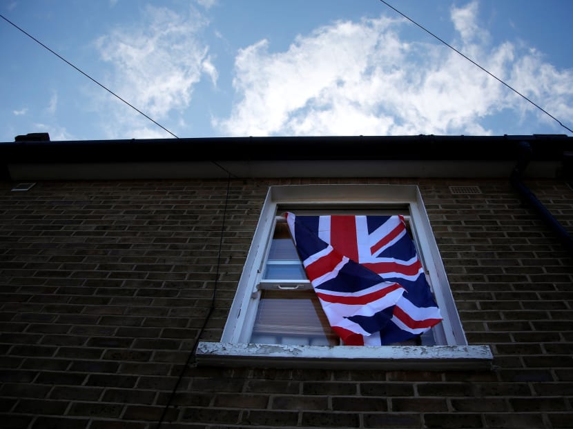 A British flag flutters in front of a window in London, Britain, on June 24, 2016 after Britain voted to leave the European Union in the EU BREXIT referendum. Photo: Reuters