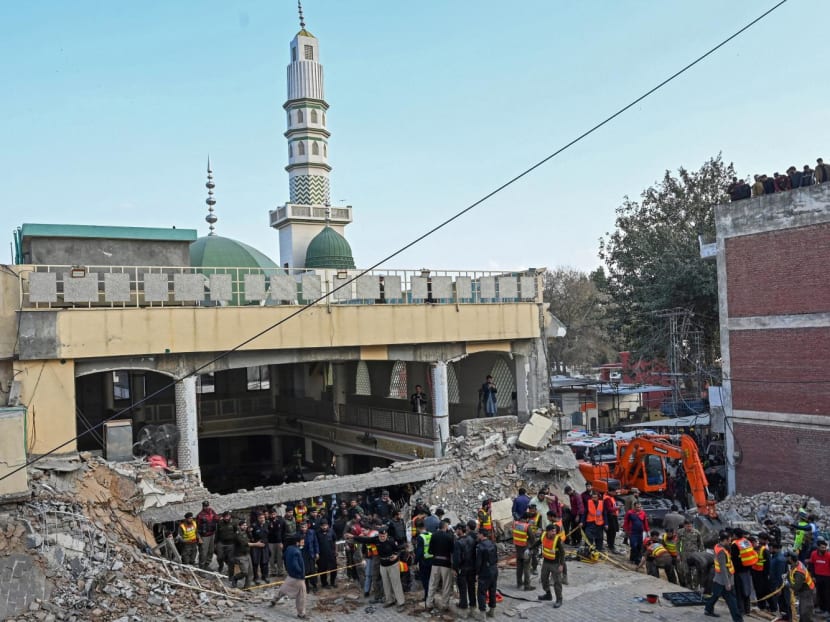 Security personnel and rescue workers prepare to search for the blast victims in the debris of a damaged mosque inside the police headquarters in Peshawar on Jan 30, 2023.