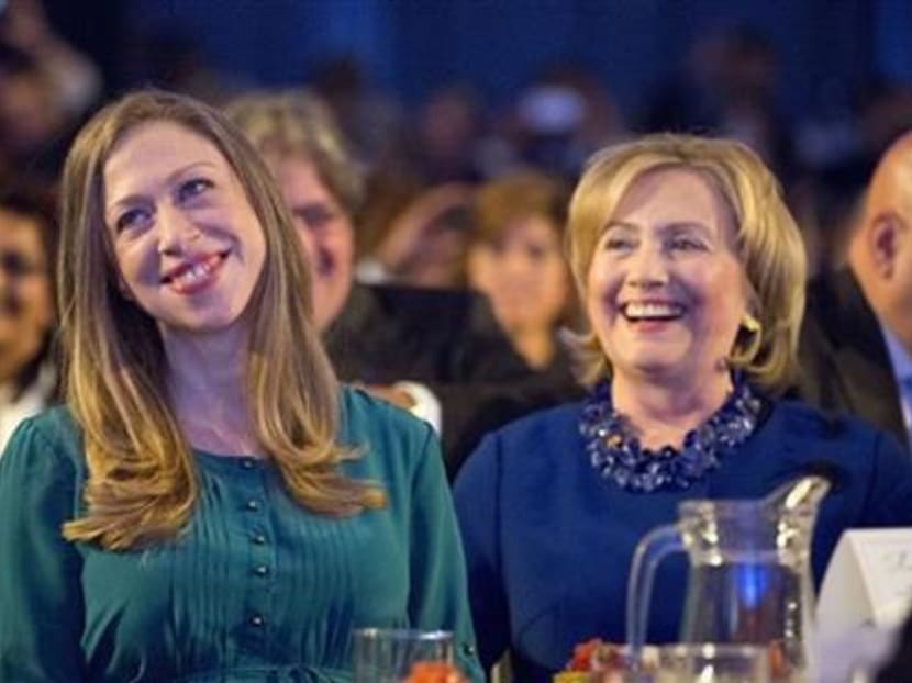 Chelsea Clinton, left, daughter of former President Bill Clinton and former Secretary of State Hillary Rodham Clinton, right, smiles after being acknowledged by President Barack Obama at the Clinton Global Initiative in New York, Tuesday, Sept 23, 2014. Photo: AP
