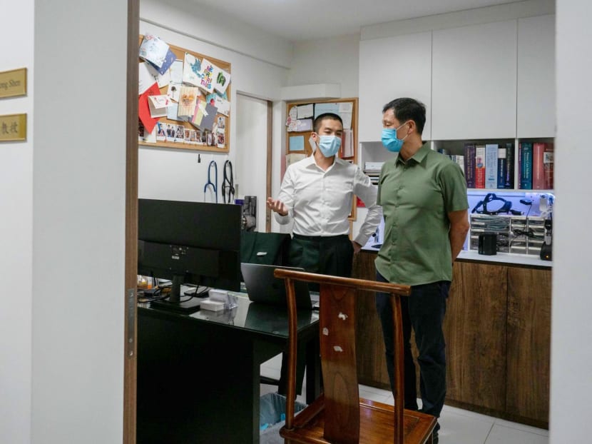 Minister for Health Ong Ye Kung (right) with a doctor at a private clinic during a media event in May 2022. 