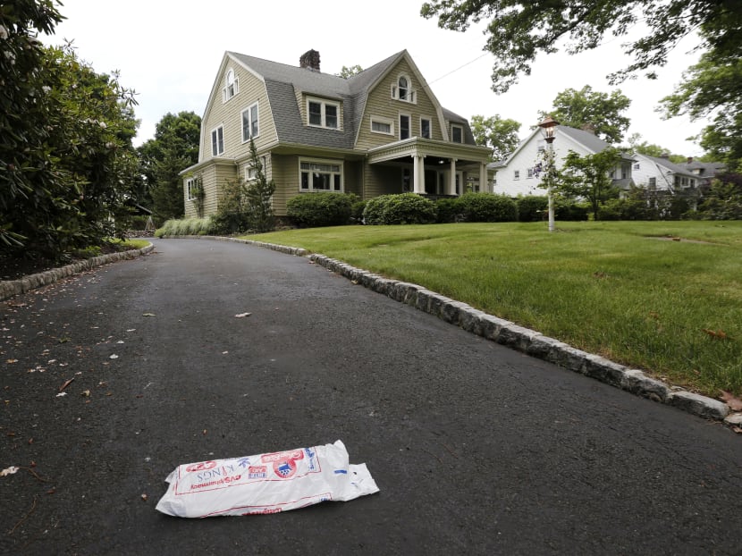 A newspaper resting on the driveway of the home Derek and Maria Broaddu. AP file photo