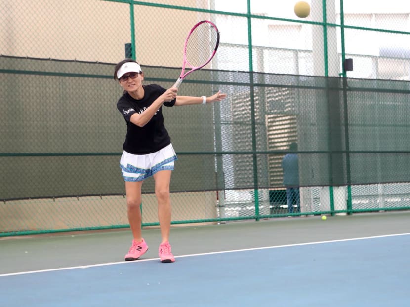 The author playing soundball, or tennis for the blind, using a sound-adapted sponge ball.