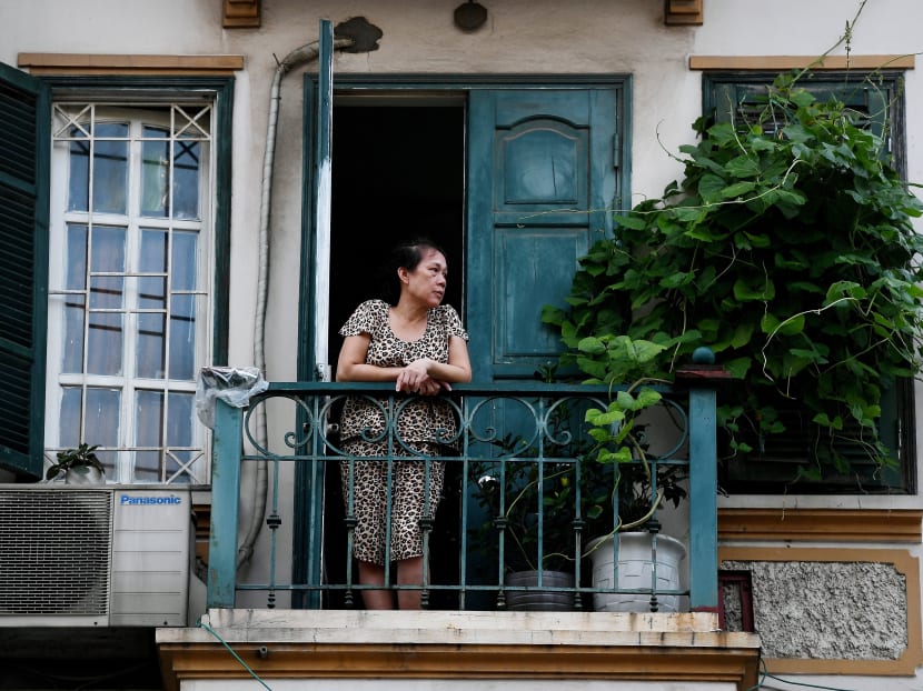A woman looking out from a balcony of her home in Hanoi, during the government-imposed lockdown to stop the spread of the Covid-19 coronavirus on Sept 2, 2021. Overlooking deserted streets, Hanoi's tiny balconies have become places of refuge as the city's locked-down residents squeeze desks, yoga mats and comfy seats for coffee into their bit of fresh air. A woman looking out from a balcony of her home in Hanoi, during the government-imposed lockdown to stop the spread of the Covid-19 coronavirus on Sept 2, 2021. Overlooking deserted streets, Hanoi's tiny balconies have become places of refuge as the city's locked-down residents squeeze desks, yoga mats and comfy seats for coffee into their bit of fresh air.