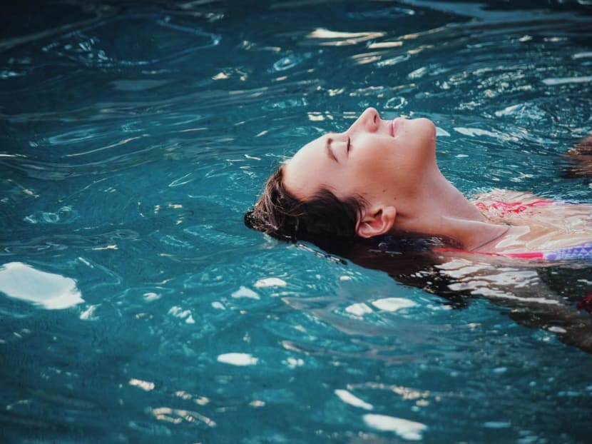 A woman relaxing on water in sunlight
A woman relaxing on water in sunlight