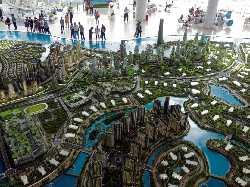 Prospects look at a model of the development at the Country Gardens' Forest City showroom in Johor Bahru, Malaysia on Feb 21, 2017.