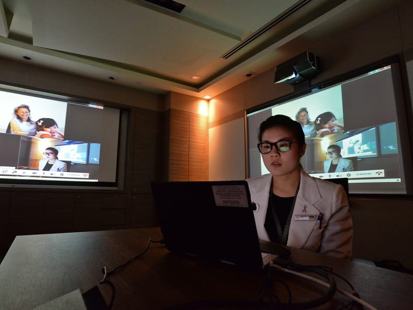 Ms Vanessa Cheong, Clinical Pharmacist at KKH's Outpatient Pharmacy, conducting a 'live' demonstration of a healthcare video consultation. Photo: Robin Choo